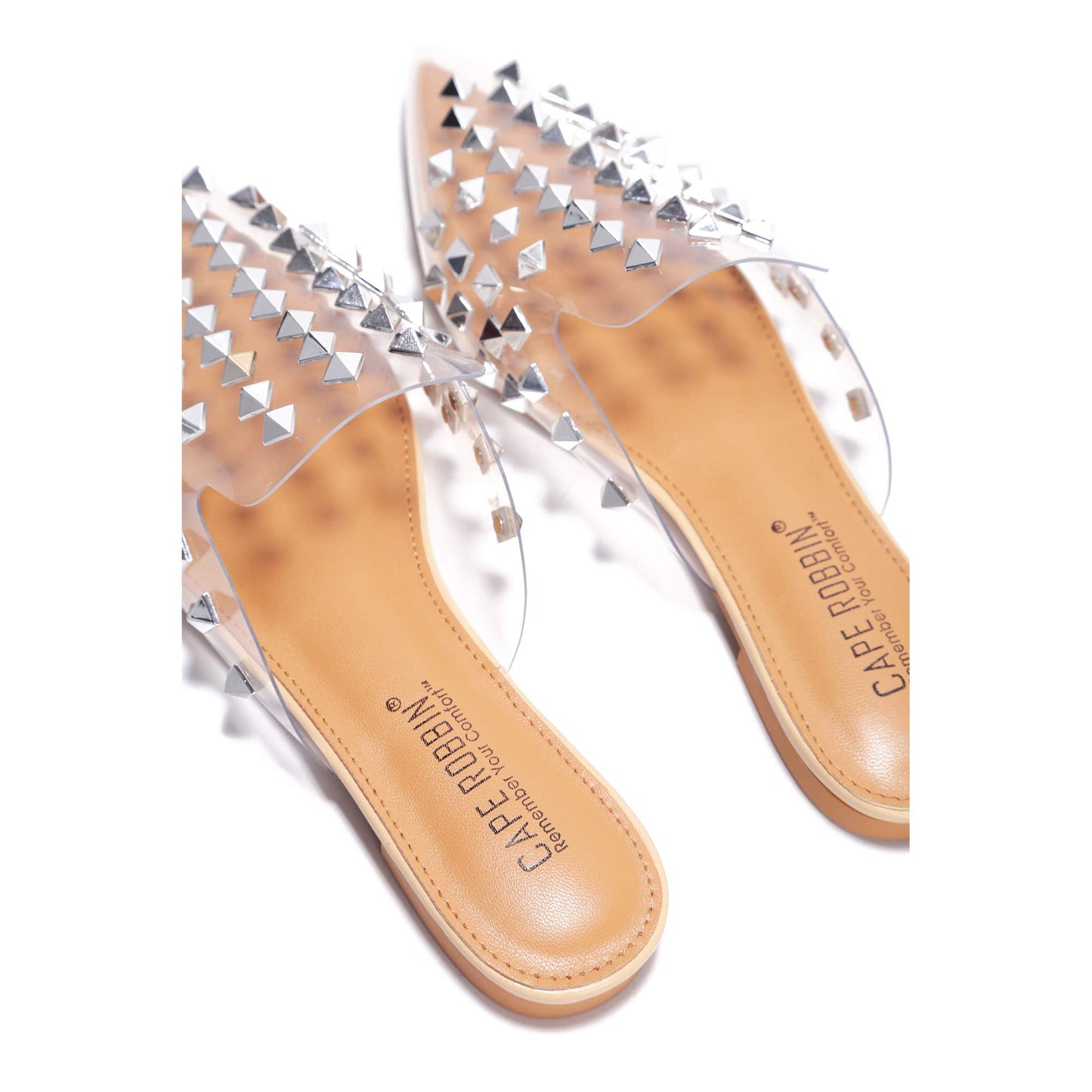 Slip into attitude with the Enny Studded Mules. Available in black faux leather or clear PVC, these pointed toe flats are your new go-to for effortless edge.